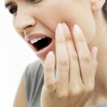 woman in tooth pain needs to find a dentist using dental marketing