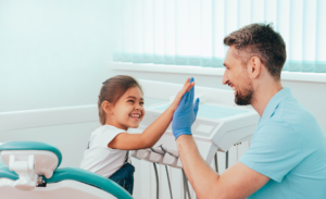 Dentist with child happy with dental marketing services with best dental marketing company. 