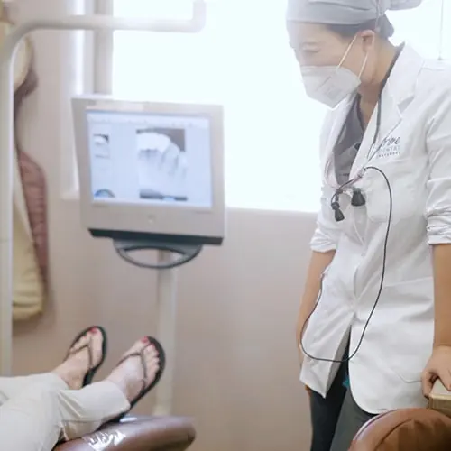 Dentist talking to patient as part of dental practice marketing