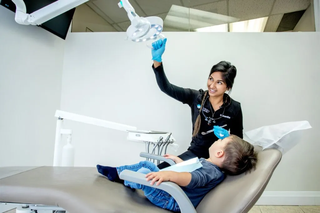 Dentists talking to her kid patient